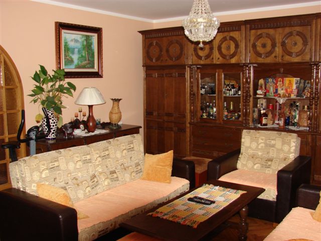 Classic-style living room with wooden furniture and a soft sofa in a house for sale, Budva, Montenegro.
