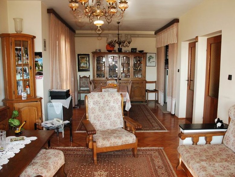 Classic living room with wooden furniture and rugs in a house for sale in Herceg Novi, Montenegro.