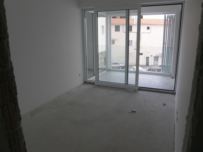 Living room in a new building in Pržno, Montenegro: panoramic windows, access to the terrace, apartment in pre-finished condition.
