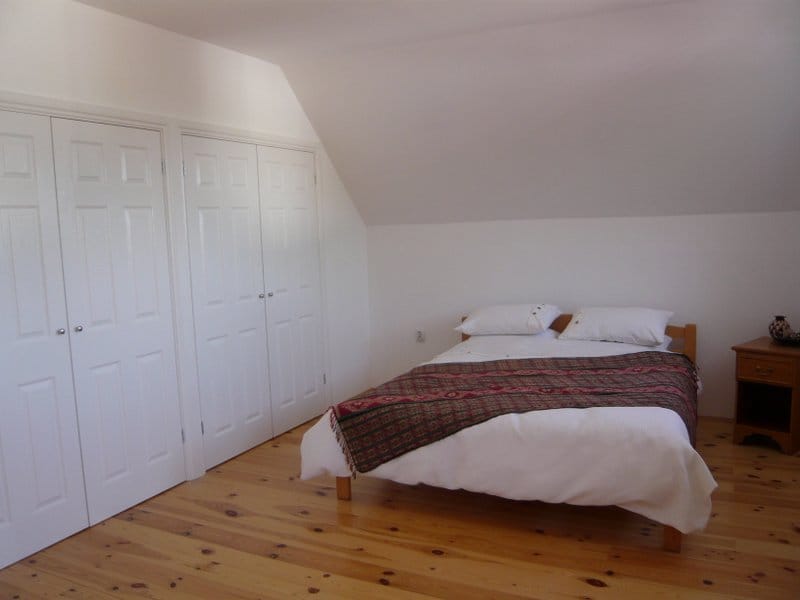 Bright bedroom with a double bed and built-in wardrobes in a house, Nikšić, Montenegro.