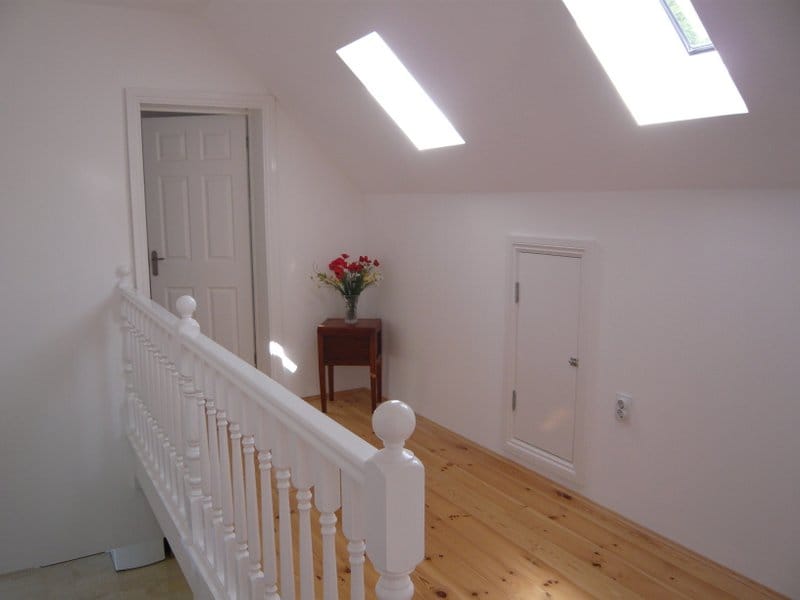 Bright attic floor with wooden flooring and skylight windows in a house, Nikšić, Montenegro.