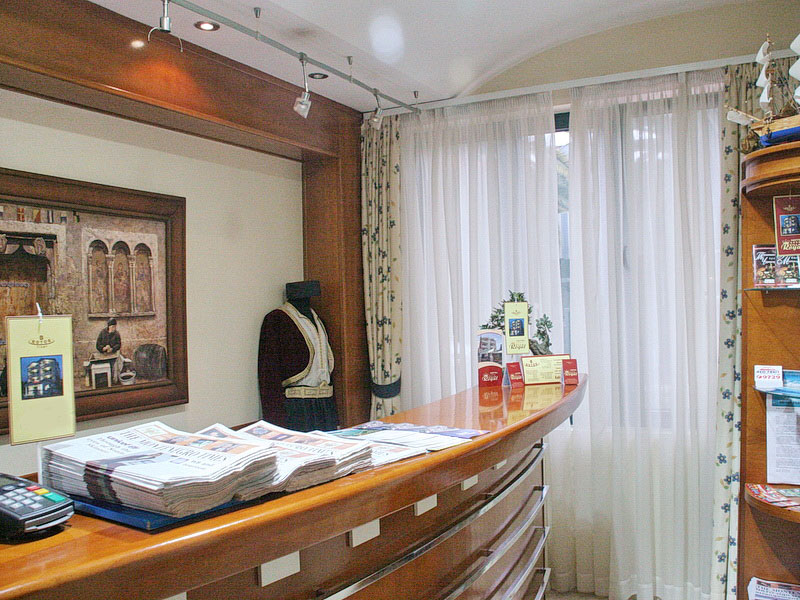 Reception desk in a hotel in Tivat, Montenegro: wood paneling, national costume, and decor in the lobby interior.