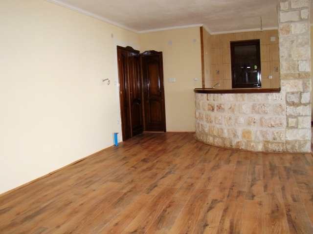 Living room in a house in Petrovac, Montenegro: interior with natural stone finishes and wooden doors.