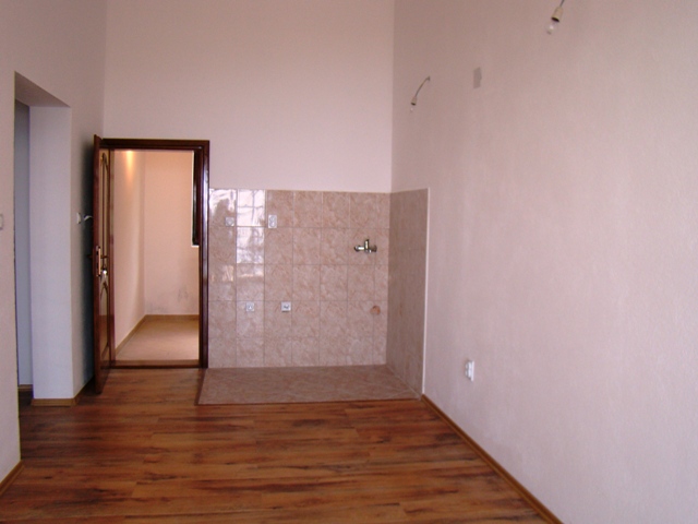 Empty kitchen with tile and laminate finishes in a house for sale, Petrovac, Montenegro.