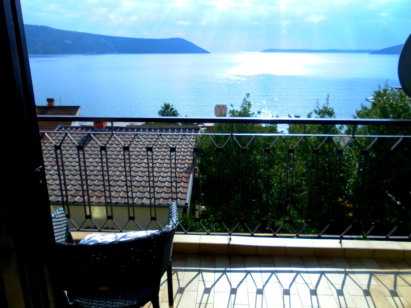 Balcony with wicker furniture and a panoramic sea view in a house, Herceg Novi, Montenegro.