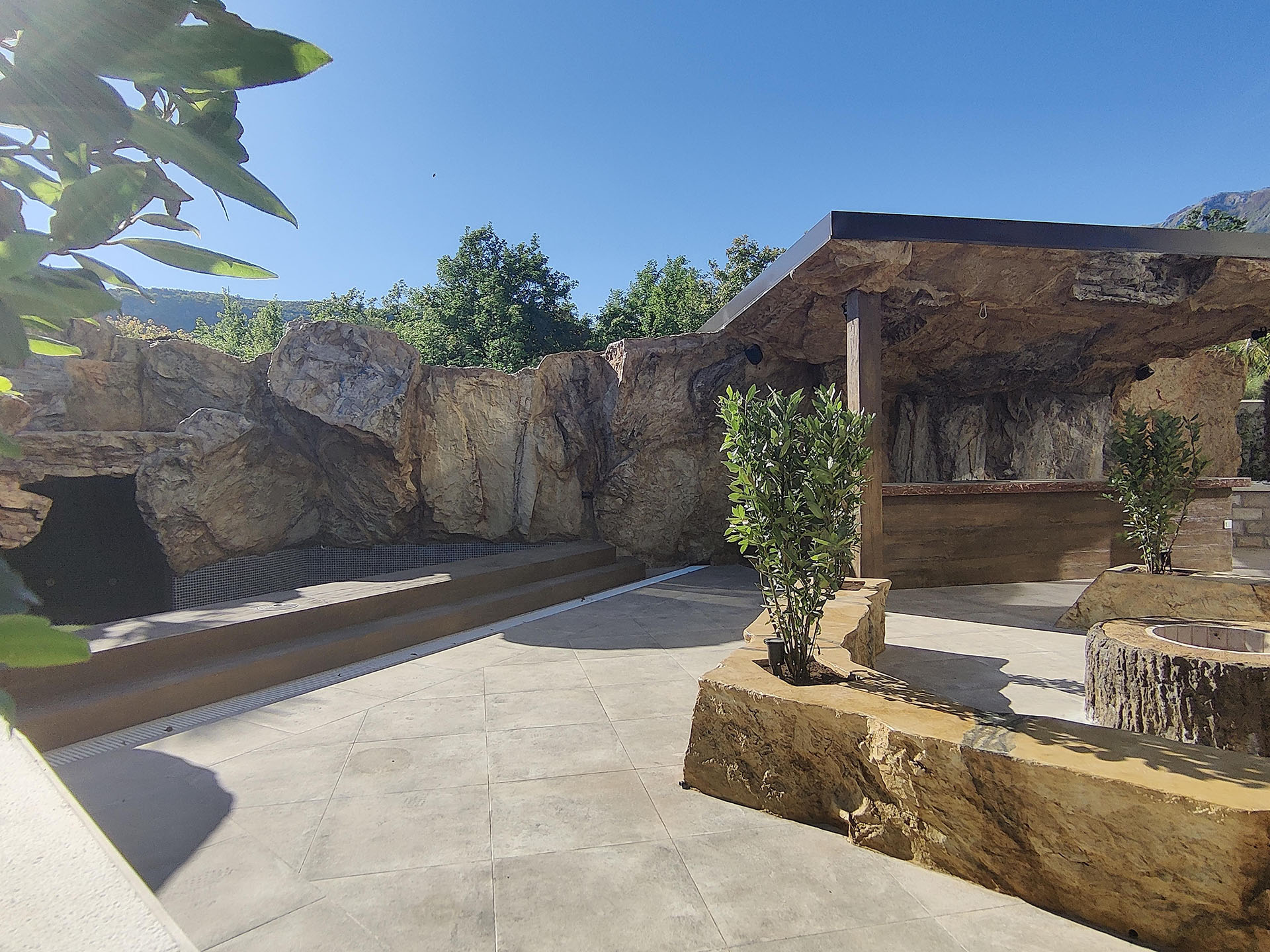 Terrace with stone decor and a lounge area in the MonteDreams residential complex, Becici, Budva Riviera, Montenegro.