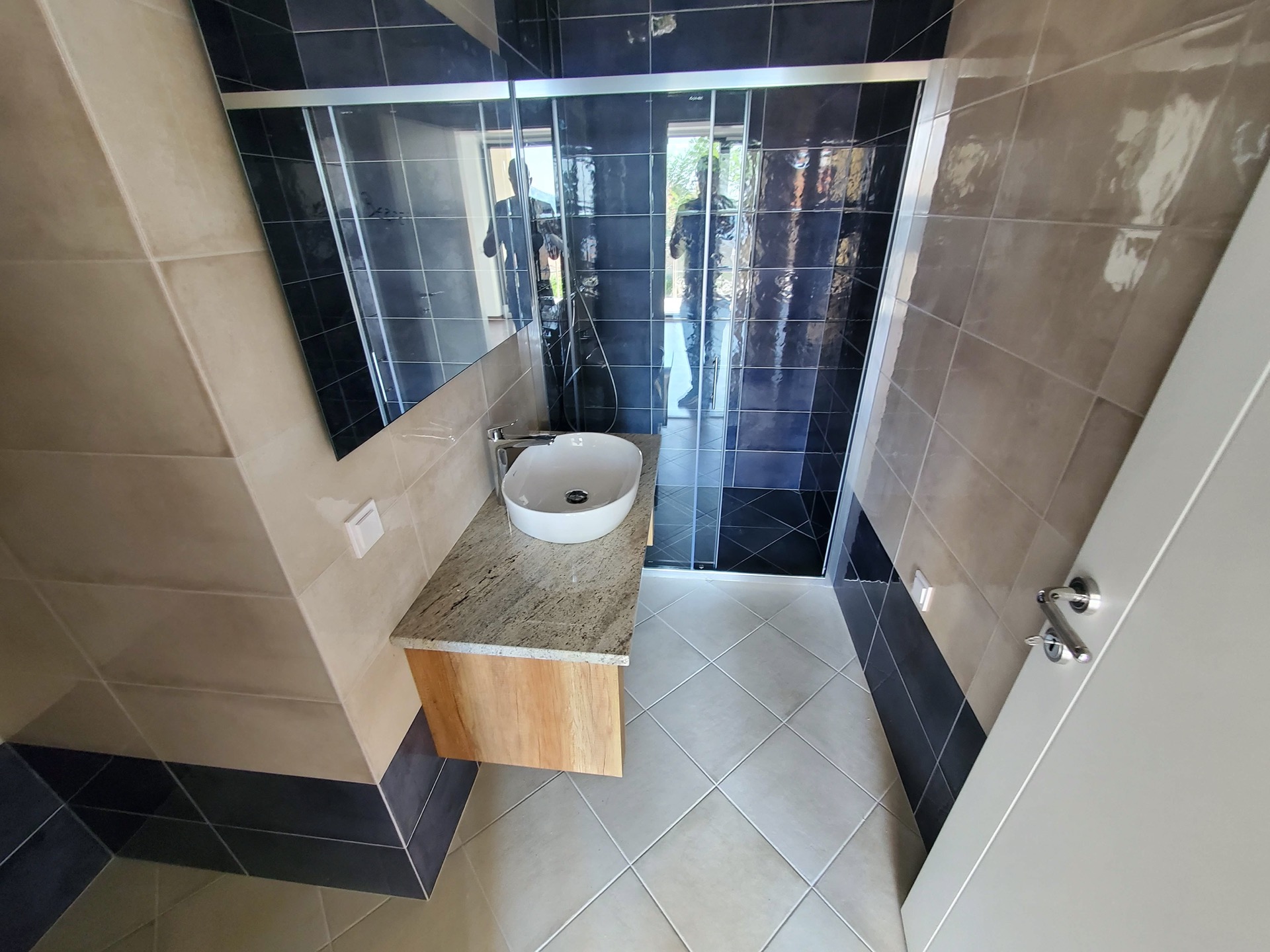 Modern bathroom with a shower cabin in MonteDreams, Becici, Montenegro: stylish finishes and fixtures.