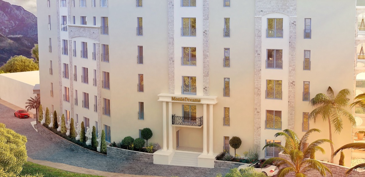 Facade of the MonteDreams residential complex in Bečići, Budva Riviera, Montenegro: a modern building with columns and palm trees.