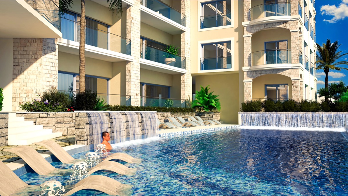 Pool with waterfall and sun loungers in the MonteDreams residential complex, Becici, Budva Riviera, Montenegro.