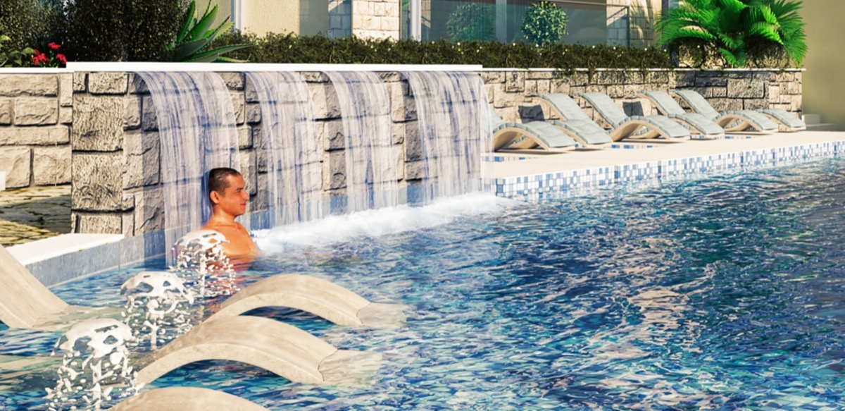 Pool with waterfall and sun loungers in the MonteDreams residential complex, Becici, Budva Riviera, Montenegro.