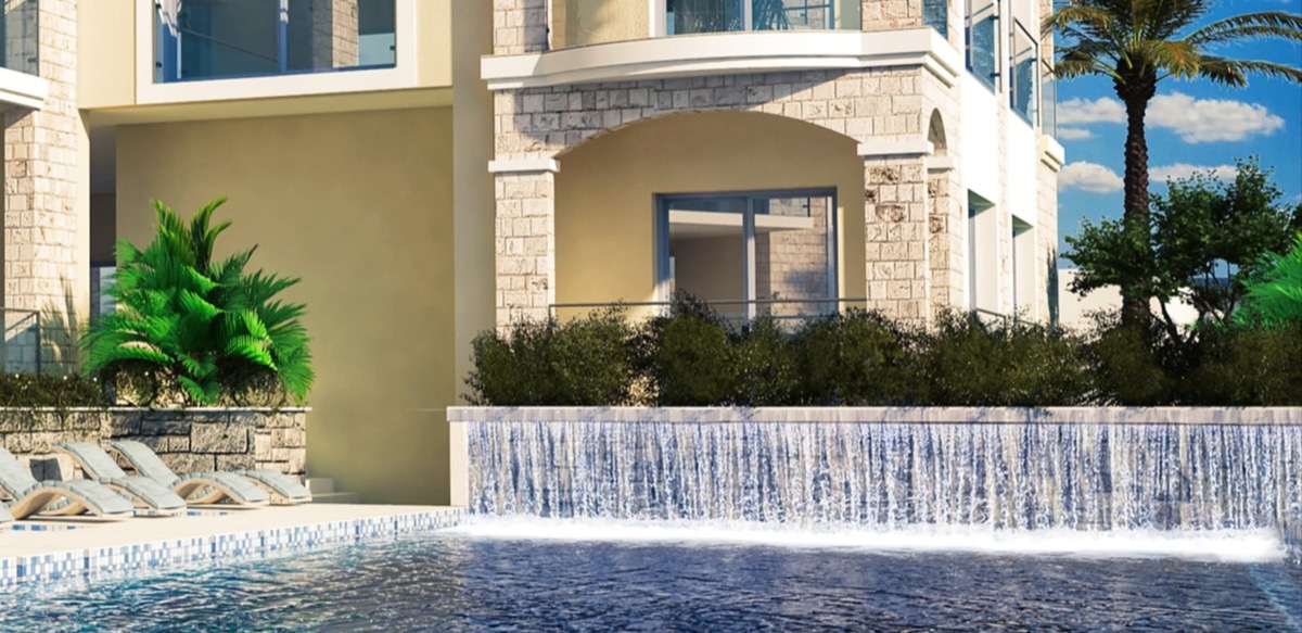 Pool with waterfall and sun loungers in the MonteDreams residential complex, Becici, Budva Riviera, Montenegro.