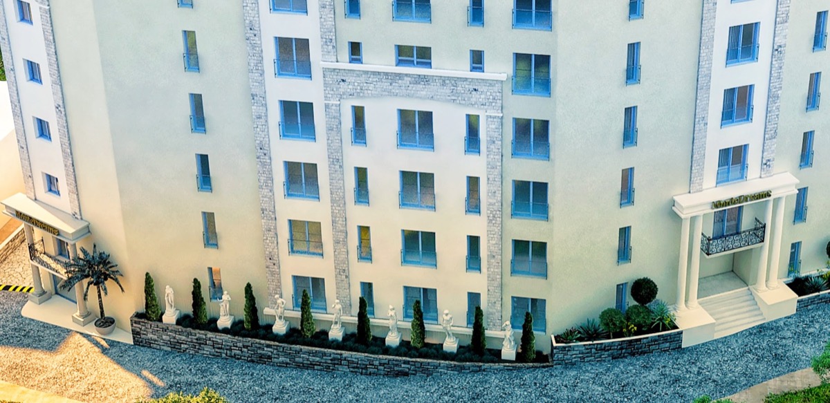 Model of the MonteDreams residential complex in Bečići, Budva Riviera, Montenegro: stone-clad facade with statues.