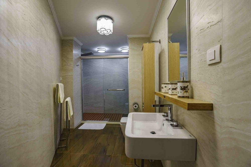 Modern bathroom with a shower cabin and tiled finishes in a villa in Sutomore, Montenegro.