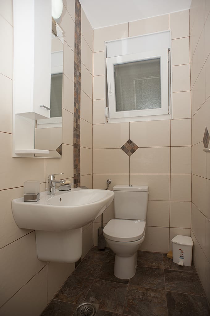 Bright bathroom with white sanitary ware and tiles in a villa in Perazića Do, Montenegro.