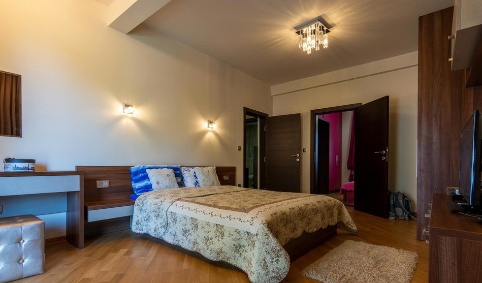 Cozy bedroom with a double bed and modern furniture in a villa in Tivat, Montenegro.