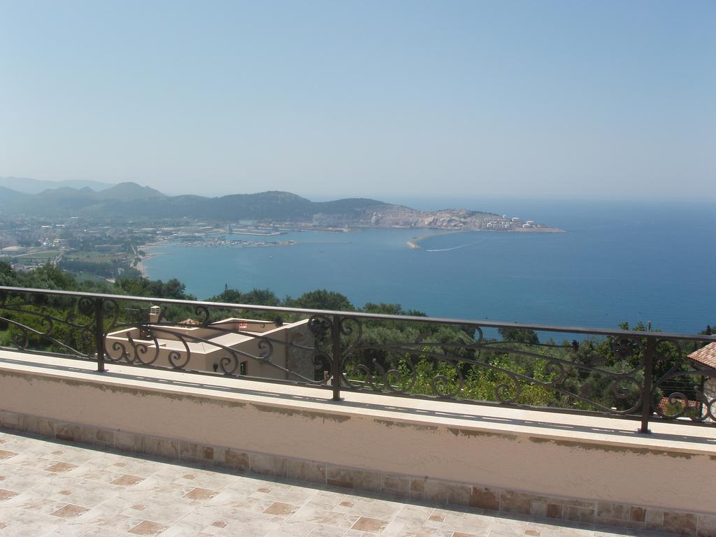 Panoramic view of the sea and bay from the terrace of a house in Šušanj, Bar Riviera, Montenegro, with wrought-iron railing.