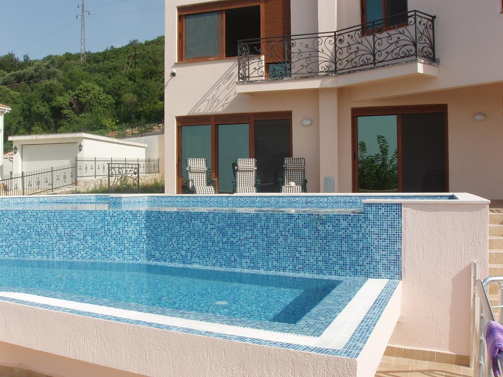 Private house with a swimming pool lined with blue mosaic tiles and a terrace in Šušanj, Bar Riviera, Montenegro.