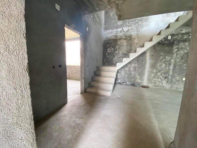 Living room in an unfinished house with a concrete staircase to the second floor, property for sale in Šušanj, Montenegro.
