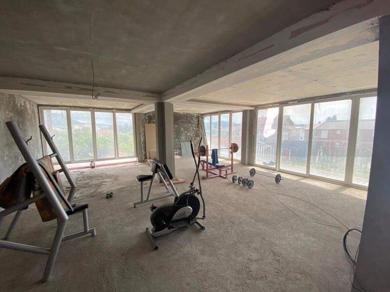Spacious space for a gym in a house in Shushan, Montenegro, with panoramic windows and exercise equipment, unfinished.