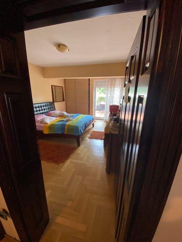 Cozy bedroom with a double bed and parquet flooring in a house in Shushan, Montenegro, with access to the terrace.