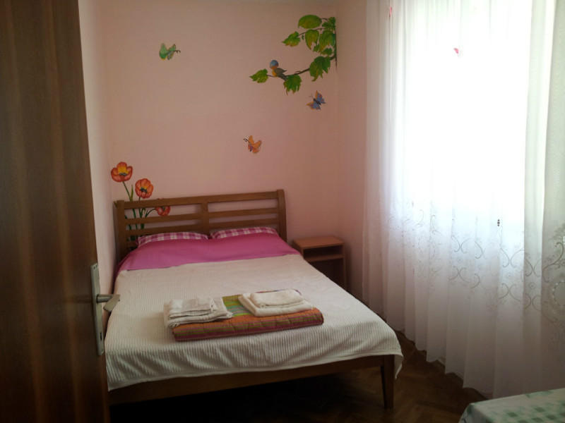 Bedroom with a double bed and wall paintings in a house for sale, Shushan, Montenegro.