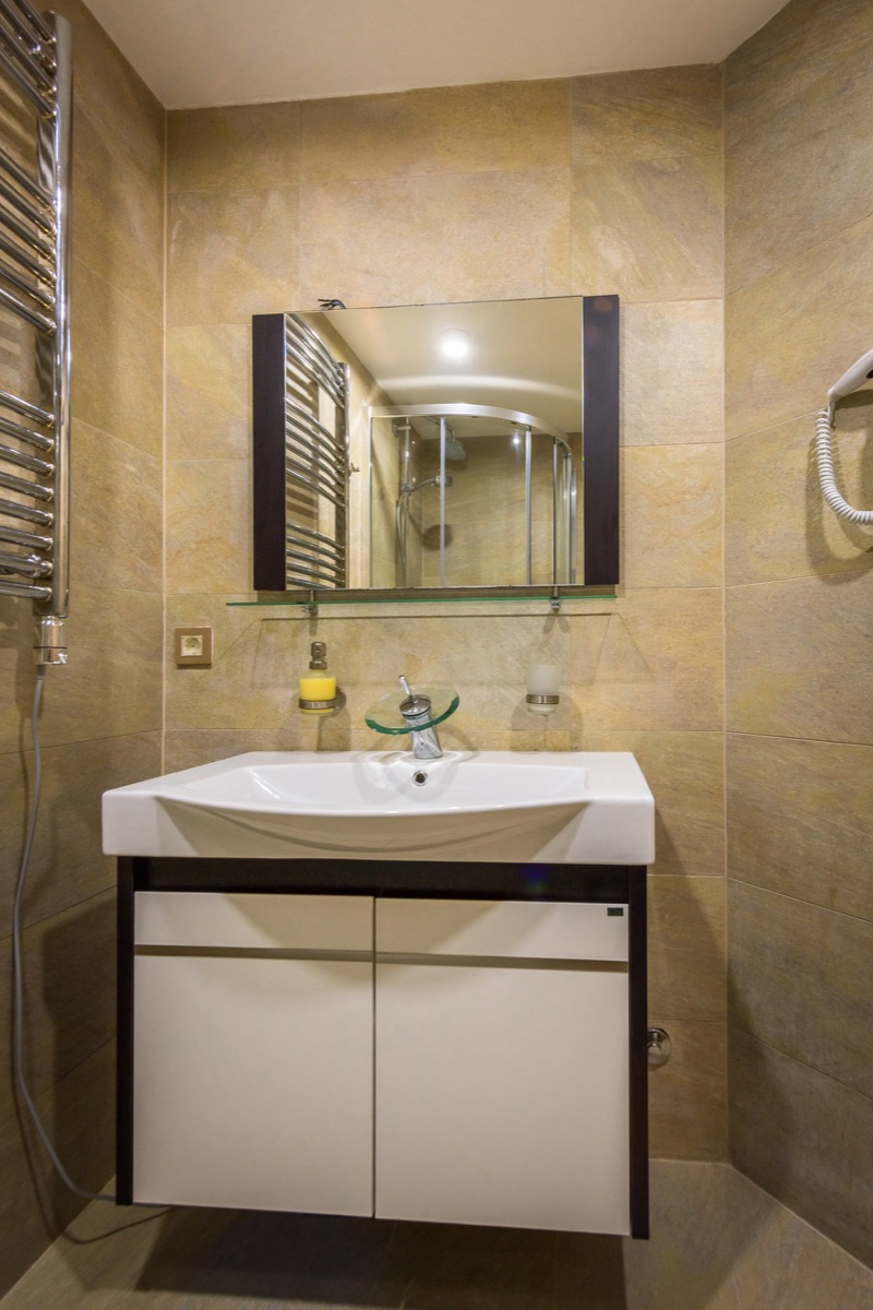 Bathroom in a villa in Krašići, Montenegro: modern vanity with a sink, mirror, and walk-in shower.