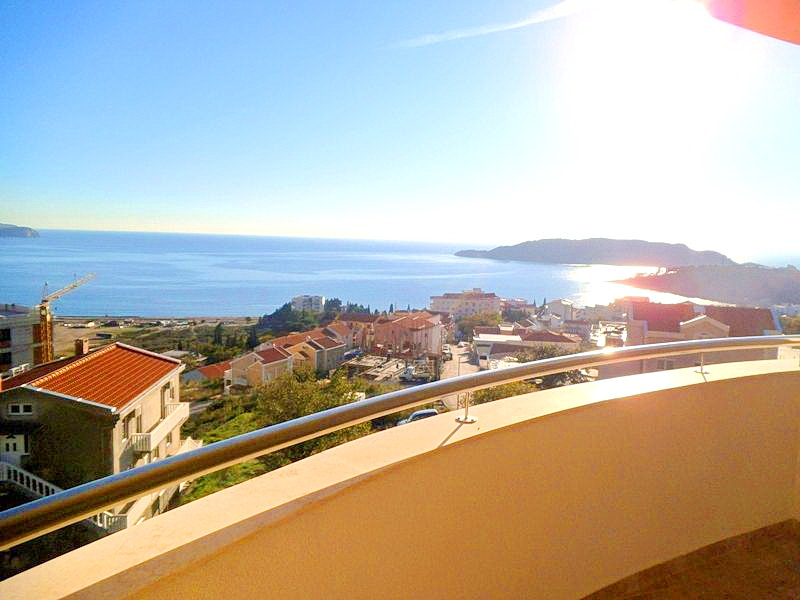 Panoramic view of the sea and Bečići from the hotel balcony in Montenegro, metal railings, sunny day.