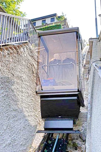 A private funicular for access to the residential complex in Morinj, Montenegro, against a backdrop of stone walls and terraces.