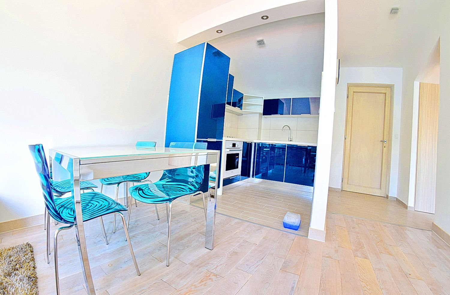 Modern kitchen with a blue fitted kitchen set and dining area in an apartment, residential complex in Morinj, Montenegro.