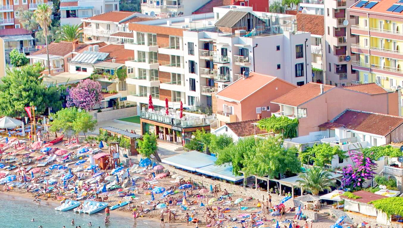 Top view of the beach and modern apartments in Rafailovici, Montenegro: resort real estate by the sea.
