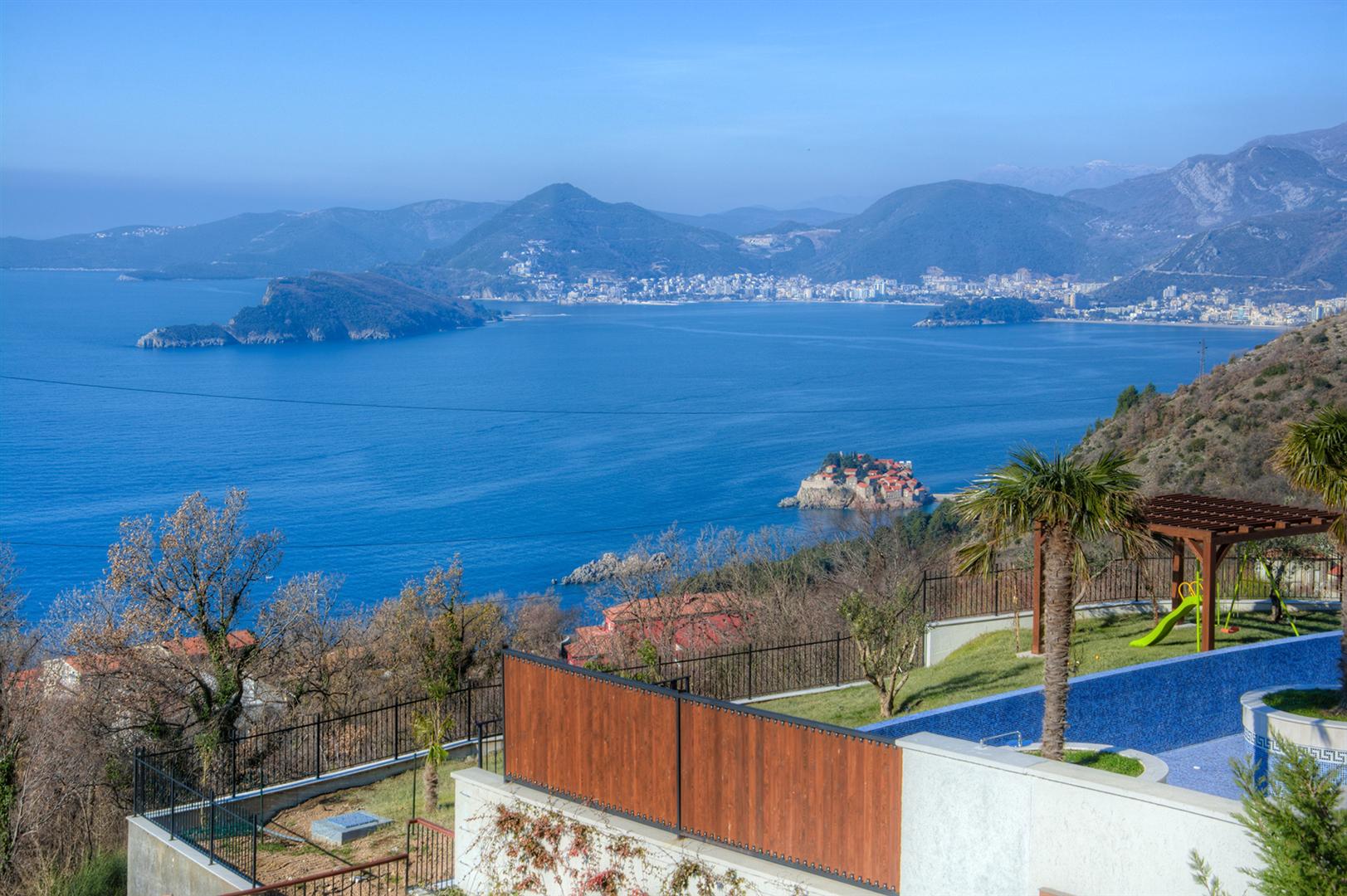 Panoramic view of the sea and Sveti Stefan island from the villa pool in Blizikuće, Montenegro.