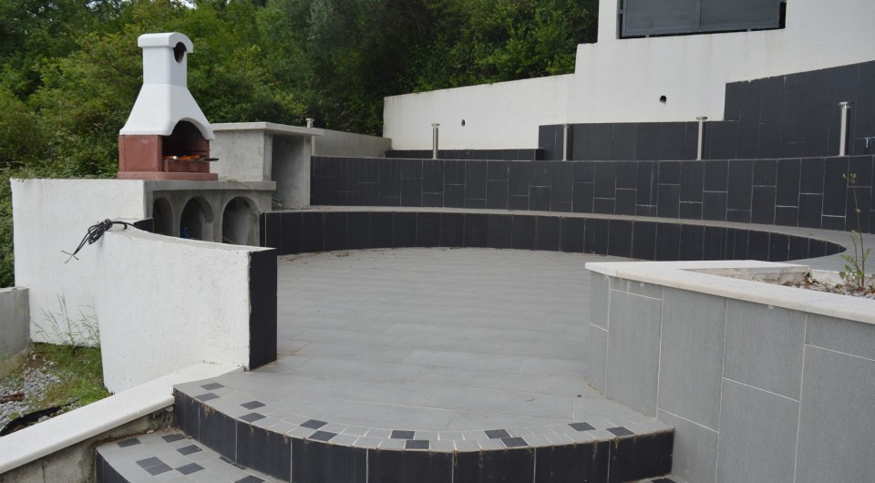 Terrace with barbecue and modern tile finish at a villa in Tivat, Montenegro.