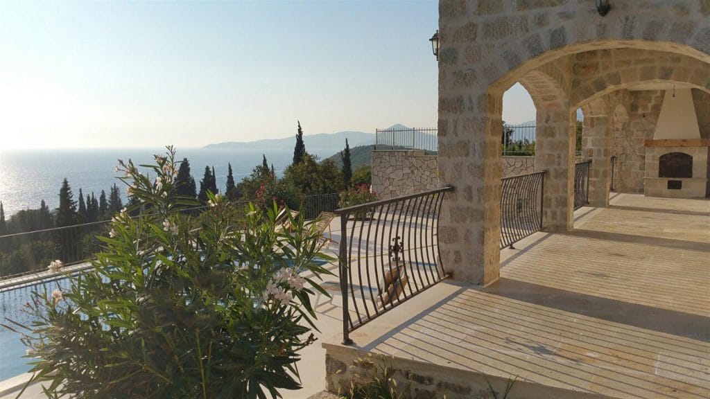 Terrace of a stone villa with a pool and panoramic sea view in Drobni Pijesak, Montenegro.