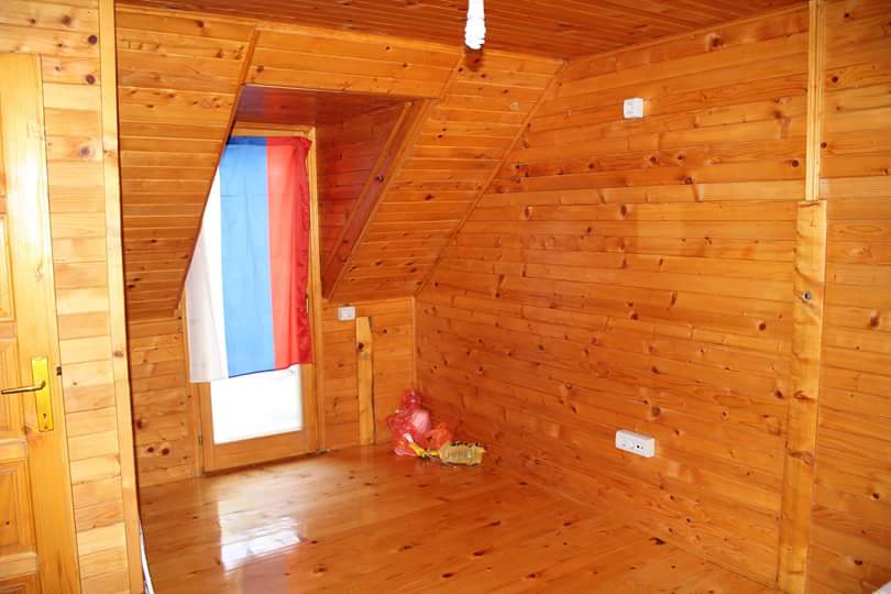 Bedroom in a house in Sutomore, Montenegro: an attic room with full wall and floor finishing in natural wood.