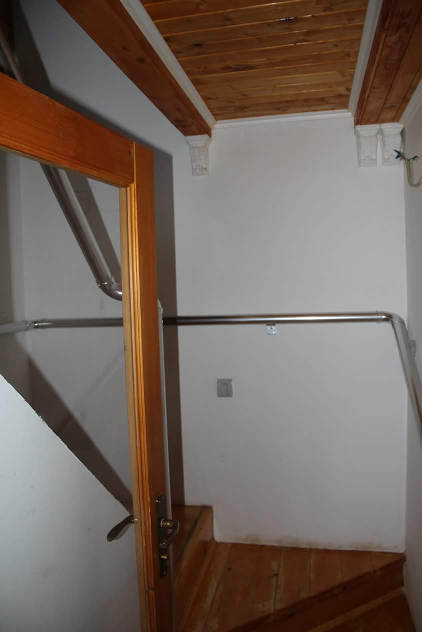 Staircase with wooden steps and metal railings in a house, Sutomore, Montenegro.