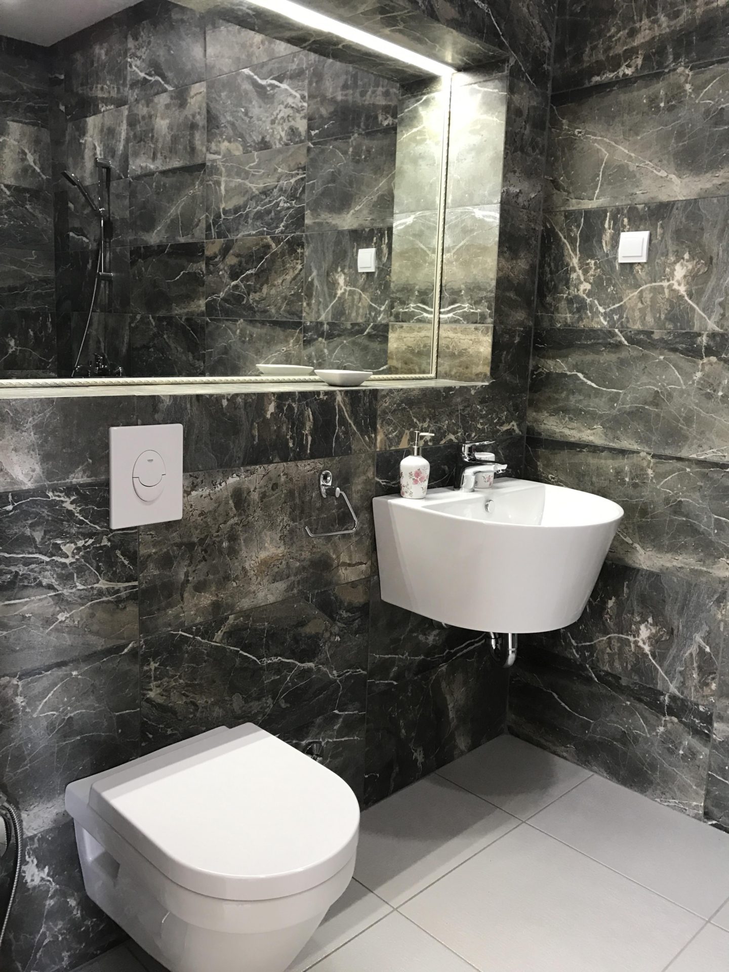 Modern bathroom with dark marble finishes in Villa No. 1011, Utjeha, Montenegro: wall-mounted fixtures.