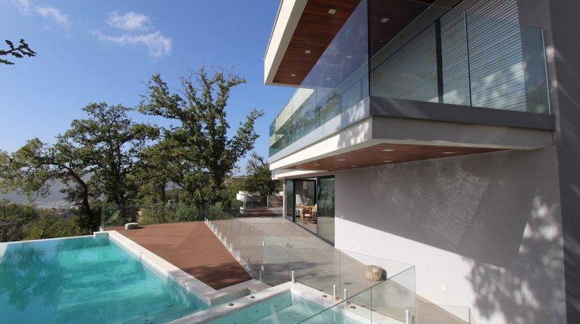 Modern villa in Herceg Novi, Montenegro: outdoor pool, wooden deck terrace, and panoramic view.