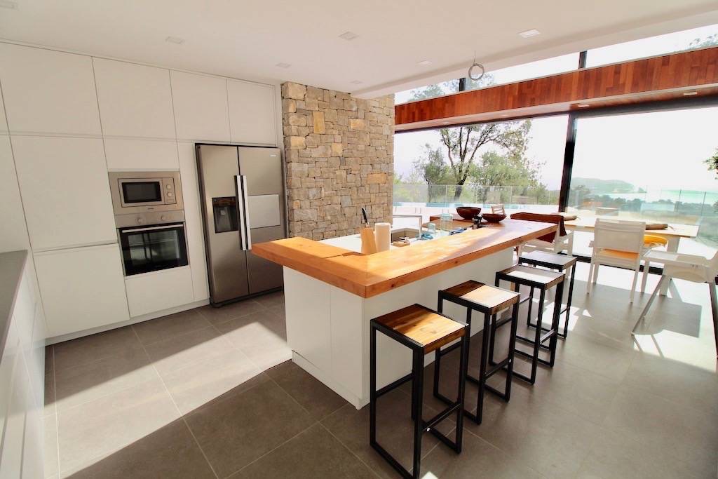 Modern kitchen with an island and panoramic sea view in a villa in Herceg Novi, Montenegro.
