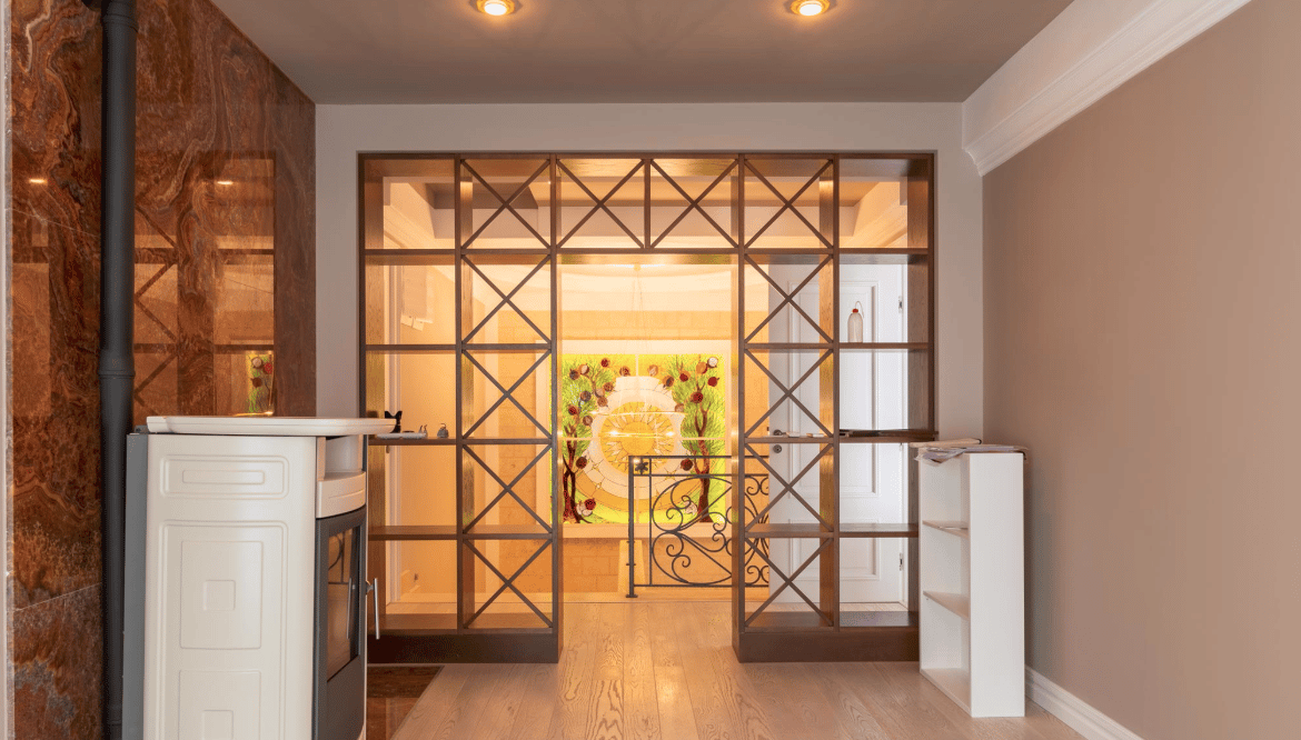 Living room with a decorative partition and fireplace in a villa in Bijela, Montenegro: a stylish interior with stained-glass decor.
