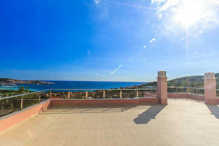 Spacious terrace with panoramic sea views in a house, Shushan, Montenegro. Sunny area with a railing.