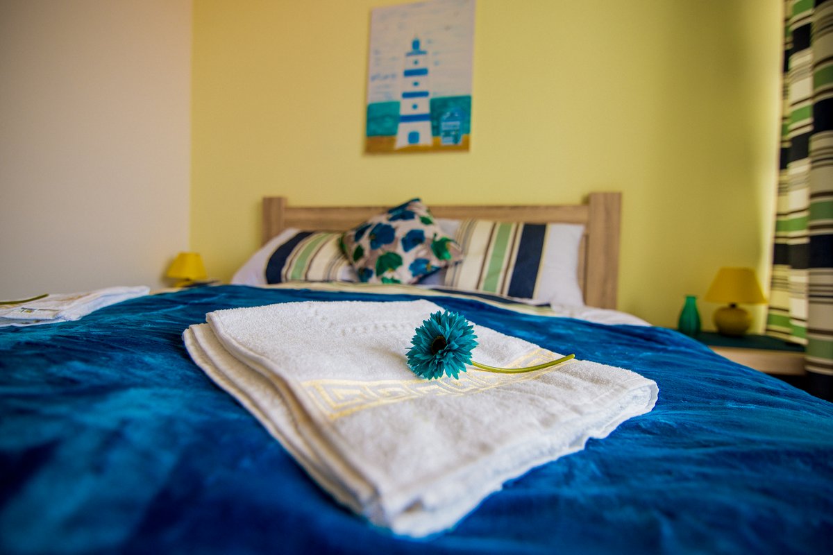 Cozy bedroom with a double bed in a villa, Krašići, Montenegro: light finishes, blue bedspread, and decor.