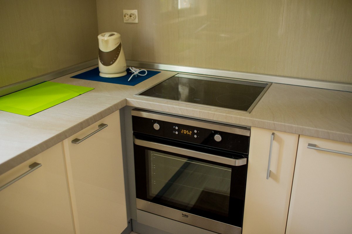Modern kitchen in a villa in Krašići, Montenegro: built-in Beko oven, cooktop, and light-colored countertop.
