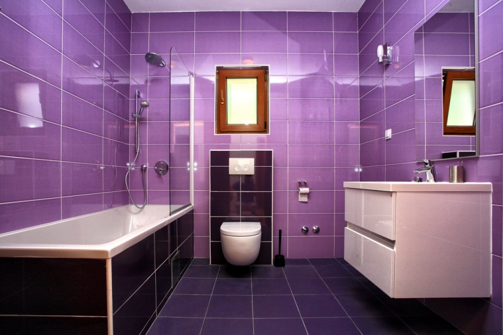Modern bathroom with purple tiles, a shower cabin, and wall-mounted fixtures in a villa in Herceg Novi, Montenegro