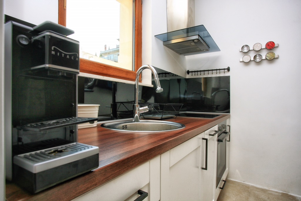 Modern kitchen with a wooden countertop and appliances in a villa in Herceg Novi, Montenegro.