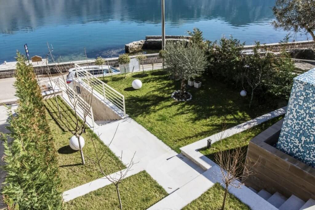 Well-maintained garden with olive trees and sea view by the villa in Stoliv, Montenegro, with access to the promenade.