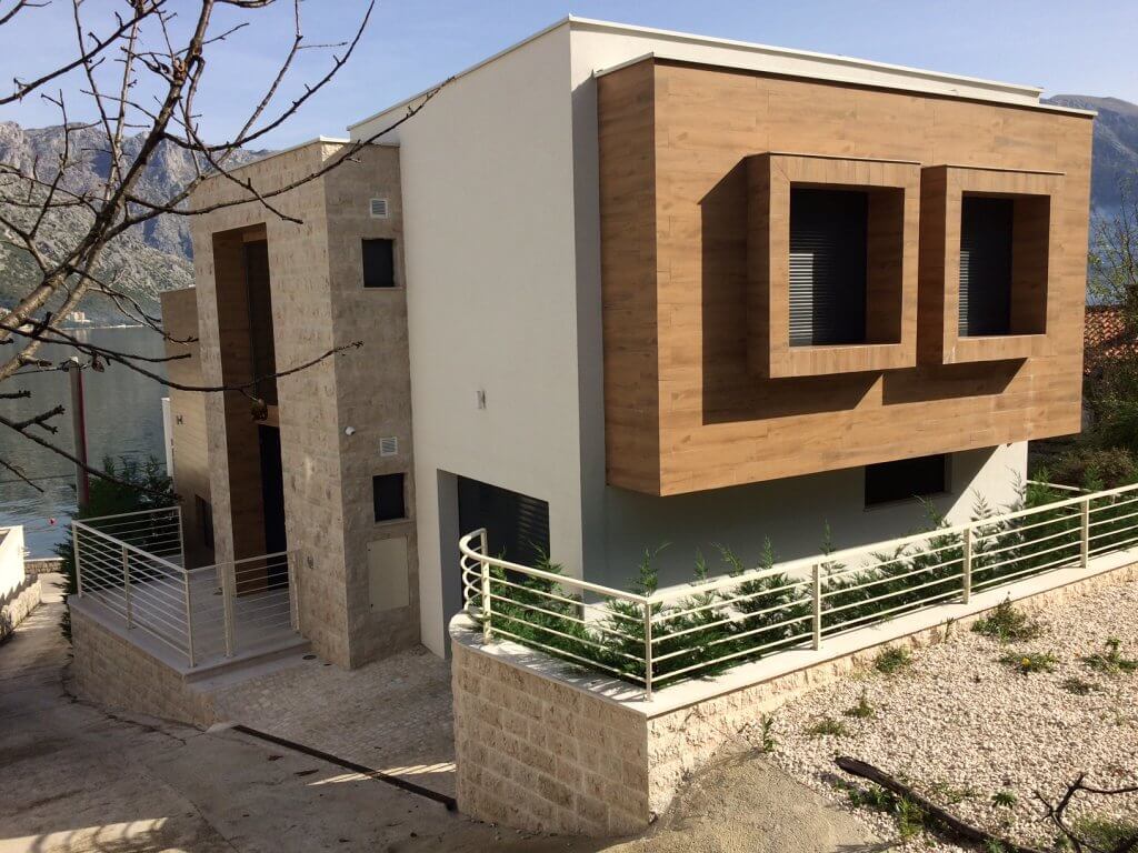Modern villa in Stoliv, Montenegro: facade with stone and wood finishes, panoramic view of the Bay of Kotor.