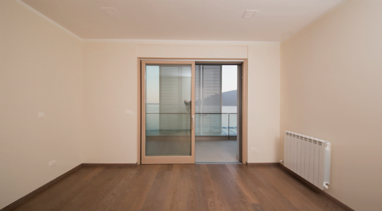 Bright living room with parquet flooring and access to a terrace with sea view in a villa, Herceg Novi, Montenegro.