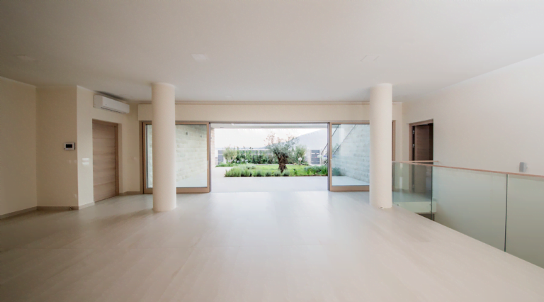 Spacious living room in a villa in Herceg Novi, Montenegro: bright interior, panoramic doors, and access to the garden.