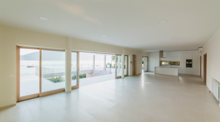 Spacious living room with panoramic windows and a modern kitchen in a villa in Herceg Novi, Montenegro.