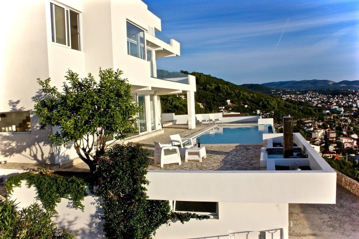 Modern villa with a pool and terrace in Dobra Voda, Montenegro: sea and mountain views, panoramic glazing.